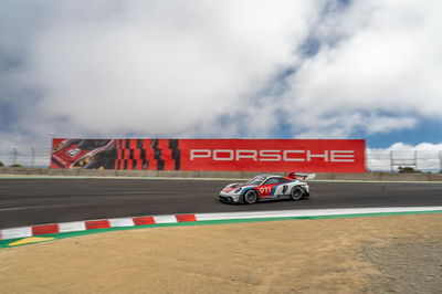 A Porsche 911 GT3 R rennsport enters the Corkscrew at Laguna Seca
