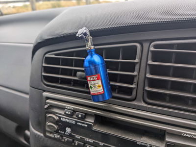 An air freshener shaped like a bottle of NOS