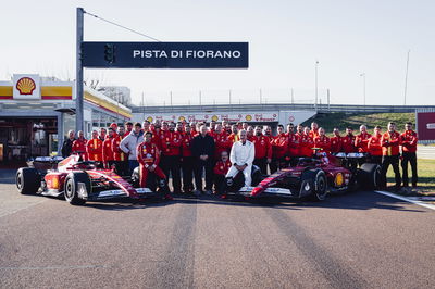 Carlos Sainz Jr. and Sr. with Ferrari F1 cars and team