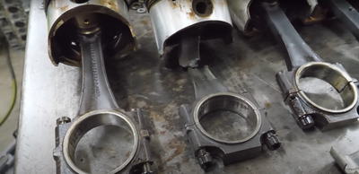 The pistons from a hydrolocked Bentley V8, including one with a snapped conrod